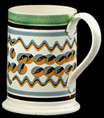 Quart mug with slip banding, cat’s eyes, trailed-tri-color waves and green-glazed roulette bands,. c. 1820, 6 inches in height - from a private collection. 